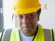 Worker in a yellow hard hat and safety vest