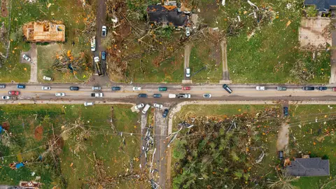Aerial view of a road through storm-damaged homes